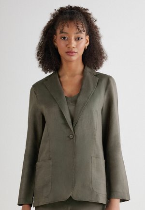 Olive green linen blazer with a single button, notched lapels, and two front pockets. Smooth texture and relaxed fit with three-quarter sleeves.
