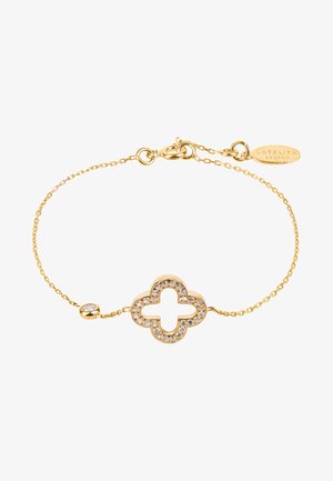 Bracciale in oro con un centro a forma di quadrifoglio impreziosito da gemme trasparenti, fissato con una chiusura e un link regolabile.