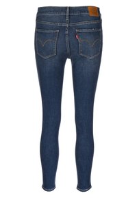 Smal passform denimjeans i mörkblått med en lätt blekning. Har en märkeslapp i läder och två bakfickor med signaturstickning.