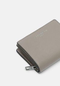 Gray leather wallet with a zip closure, textured surface, and silver embossed logo. Compact design with a neat, folded shape.
