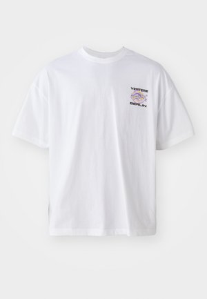 White cotton t-shirt with short sleeves, featuring a small graphic print in purple and black text reading "VERTERE BERLIN" on the left chest.