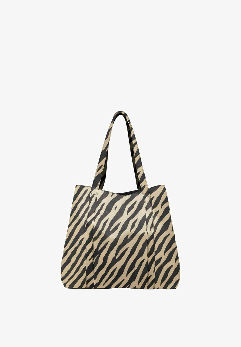 Grand sac cabas beige avec des rayures zébrées noires, doté de poignées robustes et d'une texture lisse, conçu pour une utilisation polyvalente.