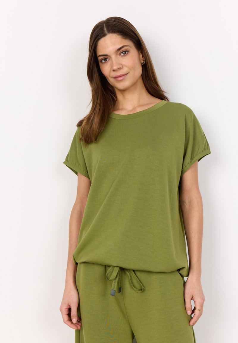 Green short-sleeve T-shirt made of soft fabric, featuring a relaxed fit, round neckline, and rolled cuff details. Worn with matching pants.