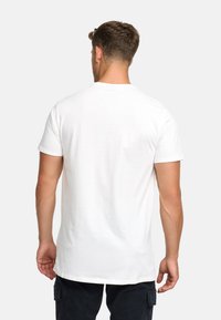 White cotton t-shirt with short sleeves, round neckline, and a plain back. Features a straight cut and smooth texture.