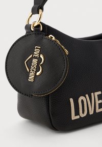 Black textured leather handbag with round coin pouch featuring gold zipper and Love Moschino logo in gold and beige embroidery.