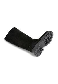 Black suede knee-high boot with a flat rubber sole. Features a textured, rugged tread for grip and a clean, smooth upper design.