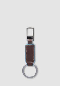 Keyring with rectangular brown leather strap, black metal clip, and round silver keyring on light gray background.