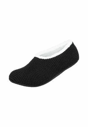 Chausson noir doux en tricot avec une doublure blanche duveteuse et une semelle plate, conçu pour le confort et la chaleur à l'intérieur.
