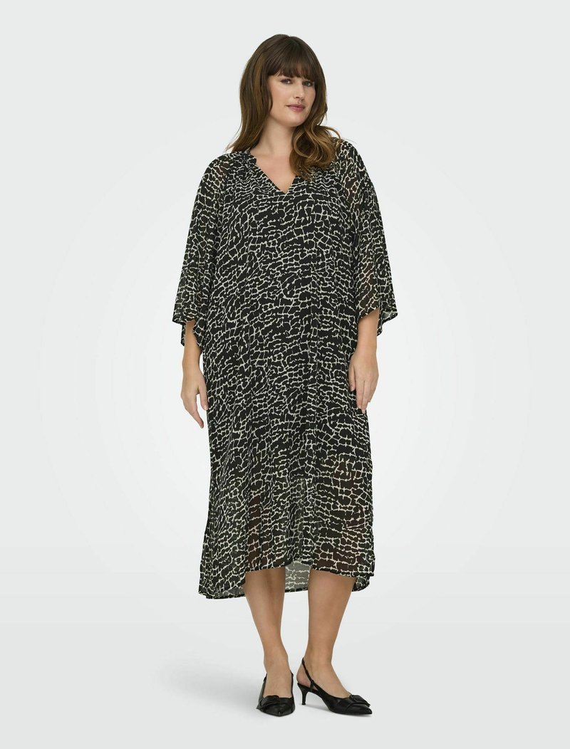 Robe à motifs noir et blanc, coupe ample, décolleté en V, longueur mi-mollet, tissu transparent, avec des manches larges et une silhouette fluide.
