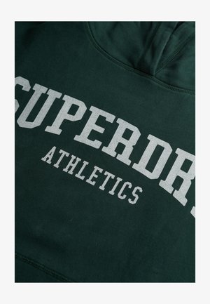 Dark green hoodie with white text "SUPERDRY ATHLETICS" printed on the front in bold, collegiate-style font.