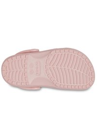 Suola di scarpa in gomma rosa con motivo di battistrada testurizzato, caratterizzata da impugnature circolari e rettangolari per una maggiore aderenza. Bordo arrotondato e design piatto.
