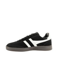 Zapatillas de ante negras con rayas blancas, diseño texturizado, suela acolchada y silueta baja. Suela exterior de goma duradera.