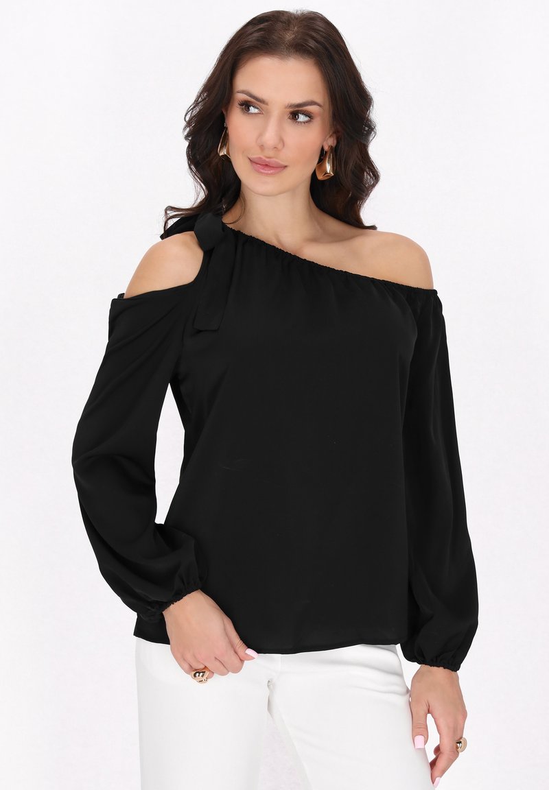 Sort off-shoulder bluse med lange pufærmer, lavet af letvægtsstof, har en sløjfe-accent på den ene skulder og elastisk kant.