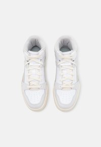 White high-top sneakers with gray accents, leather and suede materials, round toe, padded collar, and flat laces.