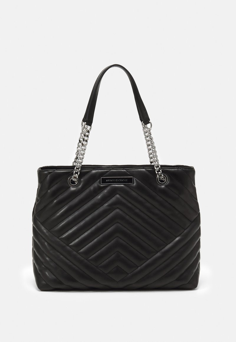 Black quilted tote bag with diagonal stitching, featuring a silver chain strap and a smooth leather texture. Logo plaque on the front.
