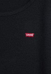 Black cotton t-shirt with a round neck and a small red embroidered Levi's logo on the chest. Smooth texture, no patterns or additional details.
