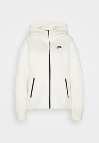Bílá mikina s kapucí, černým zipem a akcenty na kapsách. Na hrudi se nachází logo a má moderní sportovní design s raglánovými rukávy.
