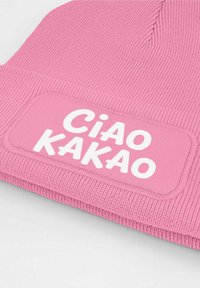 Pink knit beanie featuring a textured design and a rectangular white patch with the words "Ciao Kakao" in bold letters.