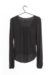 Black long-sleeve top on a hanger with a square neckline, pleated detail at the front, and slightly rounded hem; made of lightweight fabric.