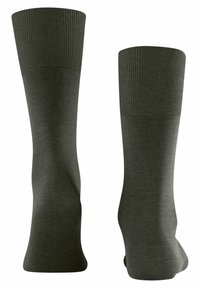 Calcetines verde oscuro con una parte superior acanalada y textura suave, con una longitud hasta la mitad de la pantorrilla y un diseño de puntera sin costuras.