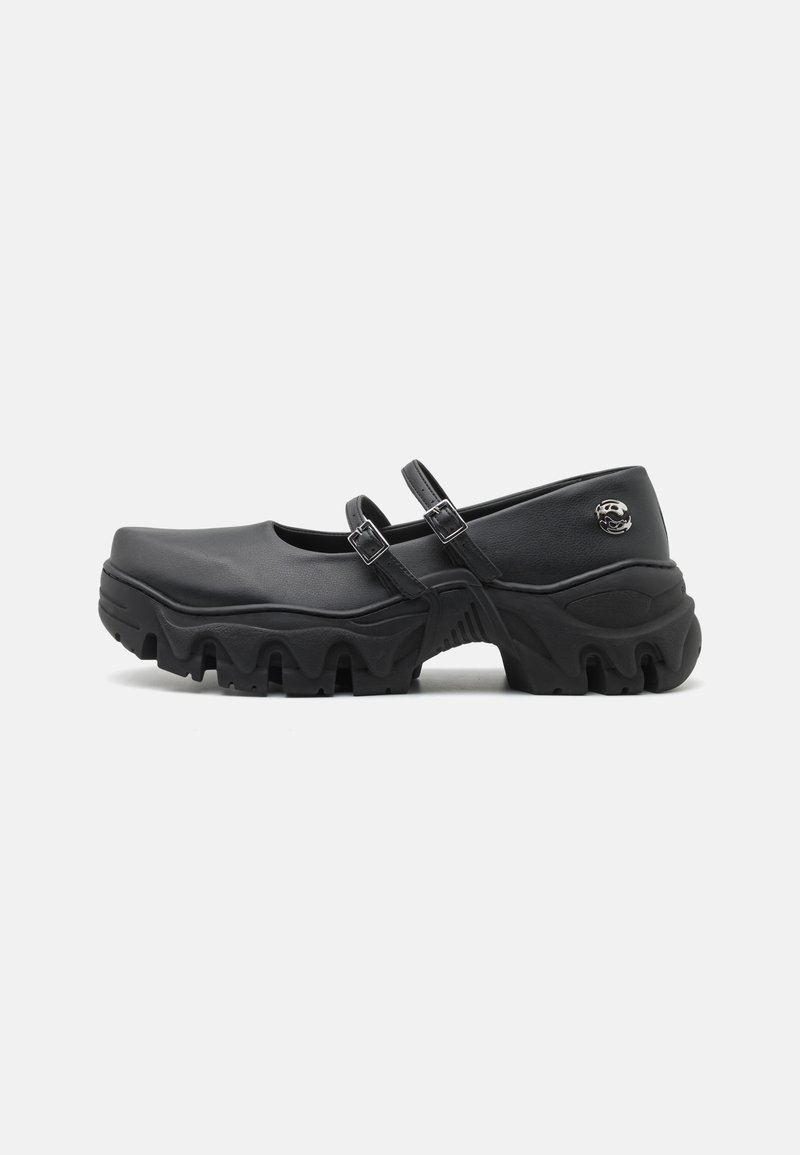 Black clogs with a smooth synthetic upper, two adjustable straps, and a thick, textured sole featuring a wave-pattern design.