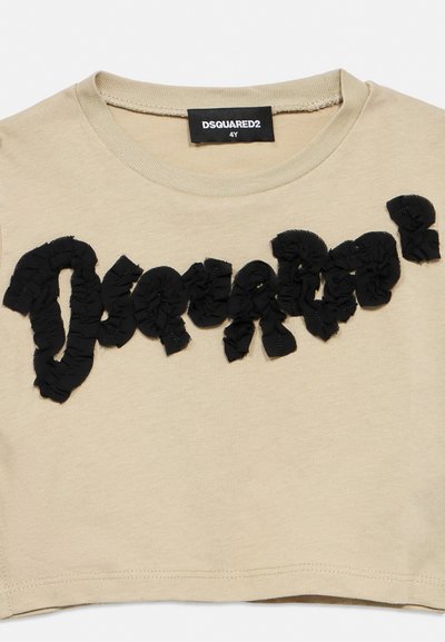Beige toddler T-shirt with black textured "DSQUARED²" lettering across the chest and a black brand label inside the neckline.