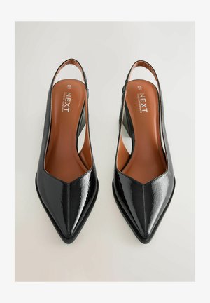 Mustad musta lakknahkaga slingback-ketsad terava ninaga, millel on avatud konts ja heleda sisetallaga, mis näitab nähtavat brändi logo.