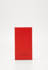 Red rectangular packaging with a smooth finish. The front features the word "VALENTINO" printed in a simple black font at the bottom.