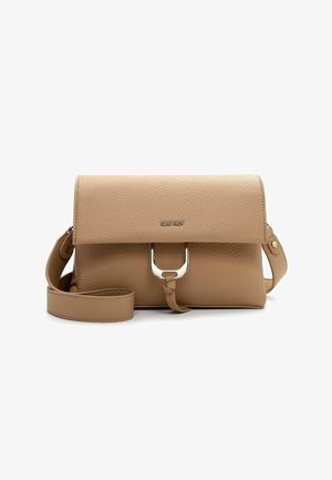 Beige textured leather crossbody bag with flap closure, silver U-shaped metal detail, knot accent, and adjustable strap.