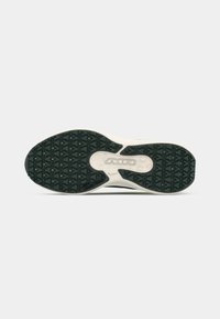 Zwarte rubberen sneakerzool met een gestructureerd gripoppervlak, voorzien van een witte tussenzool en een ronde uitsparing gelabeld "AIR."