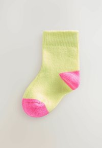 Green sock with a ribbed texture, featuring a pink heel and toe. The design includes a contrasting color block at the toe area.