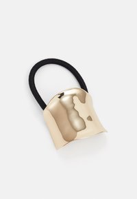 Gold-colored metal hair accessory with a curved design, featuring a black elastic band for secure styling. Smooth texture, reflective finish.