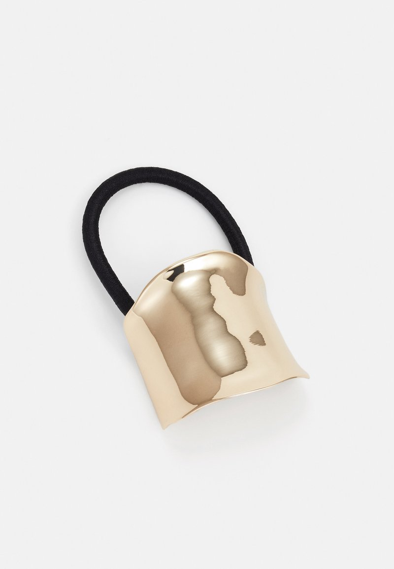 Gold-colored metal hair accessory with a curved design, featuring a black elastic band for secure styling. Smooth texture, reflective finish.