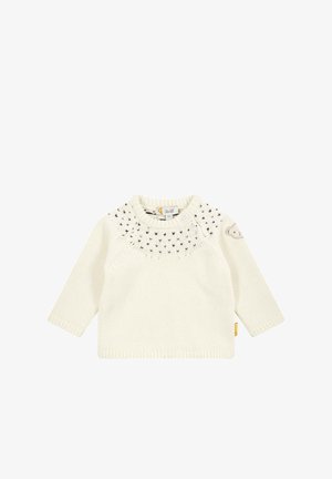 Suéter tejido de color crema con mangas largas, con un motivo en el canesú y un pequeño acento de oso en la manga. Presenta un escote redondo y etiqueta.