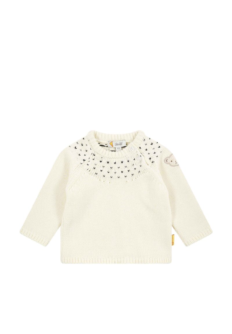 Maglione lavorato a maglia di colore crema con maniche lunghe, yoke decorato e un piccolo accento a forma di orso sulla manica. Presenta un collo rotondo e un'etichetta.