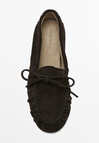 Dark brown suede moccasin-style shoe with a rounded toe, decorative stitching, and bow detail on the front. Soft, textured insole visible.