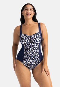 Üksik ujumistrikoo, mis sisaldab tumesiniseid külgpaneele ja mustrilist esiosa pastelltoonis punktidega. Reguleeritavad rihmad ja kogutud keskdetail.