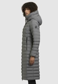 Gray long puffer coat with a hood, featuring quilted design, zippered side pockets, and a round logo patch on the left shoulder.