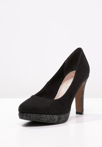 Black suede high-heeled shoe with a round toe, featuring a sparkly metallic platform and heel accent for added detail.