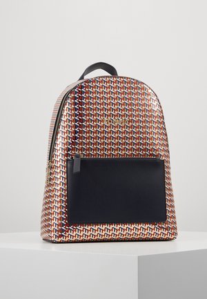 Backpack with multicolor geometric pattern, front black zip pocket, gold-toned zipper, and black handle on top, displayed on white surface.