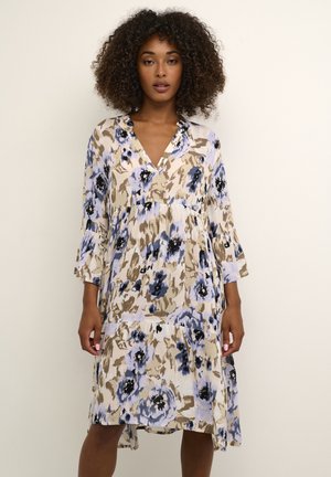 Floral dress in beige, light blue, and black. Features a V-neck, three-quarter sleeves, and a flowy, tiered design with a textured fabric.