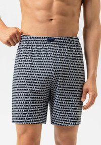 Marineblauwe en witte boxer shorts met een patroon van kleine olifanten, een elastische tailleband en een zachte, lichte stof die geschikt is voor casual aankleding.