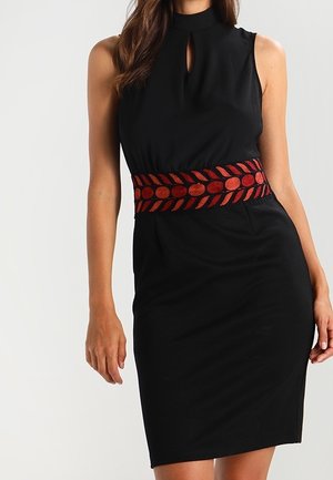 Sleeveless black knee-length dress with high neckline and keyhole detail, featuring wide red and black patterned belt at the waist.