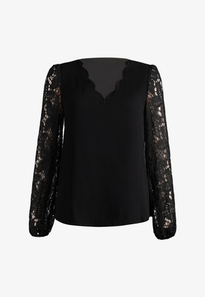 Blouse noire avec un col en V festonné et des manches longues en dentelle florale transparente avec des poignets élastiques.