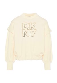 Felpa color crema con polsini e orlo a coste. Presenta la scritta "DKNY" in stampa metallica dorata. Tessuto morbido e design a vestibilità rilassata.