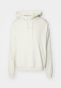 Cream hoodie with a drawstring hood, front pocket, and ribbed cuffs. Features subtle brand name embroidery in the center. Soft fabric texture.