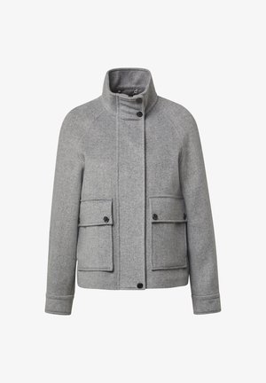 Chaqueta de mezcla de lana gris con un cuello alto, mangas raglán, dos bolsillos frontales y cierres de botón negros. Detalle de textura de espiga.