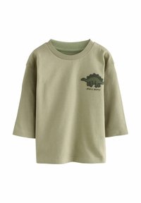 Grünes Kurzarm-T-Shirt aus weicher Baumwolle. Mit einem strukturierten Dinosaurier-Graphic in Dunkelgrün und dem Text "stomp stomp" darunter.