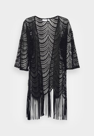Kimono en dentelle noire avec un ourlet à franges. Présente un motif en vagues sur l'ensemble et des manches courtes. Design à front ouvert pour un enfilage facile.