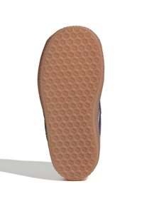 Semelle de chaussure en caoutchouc avec une surface antidérapante texturée en forme d'étoile. Couleur marron clair, forme arrondie et bord légèrement relevé.